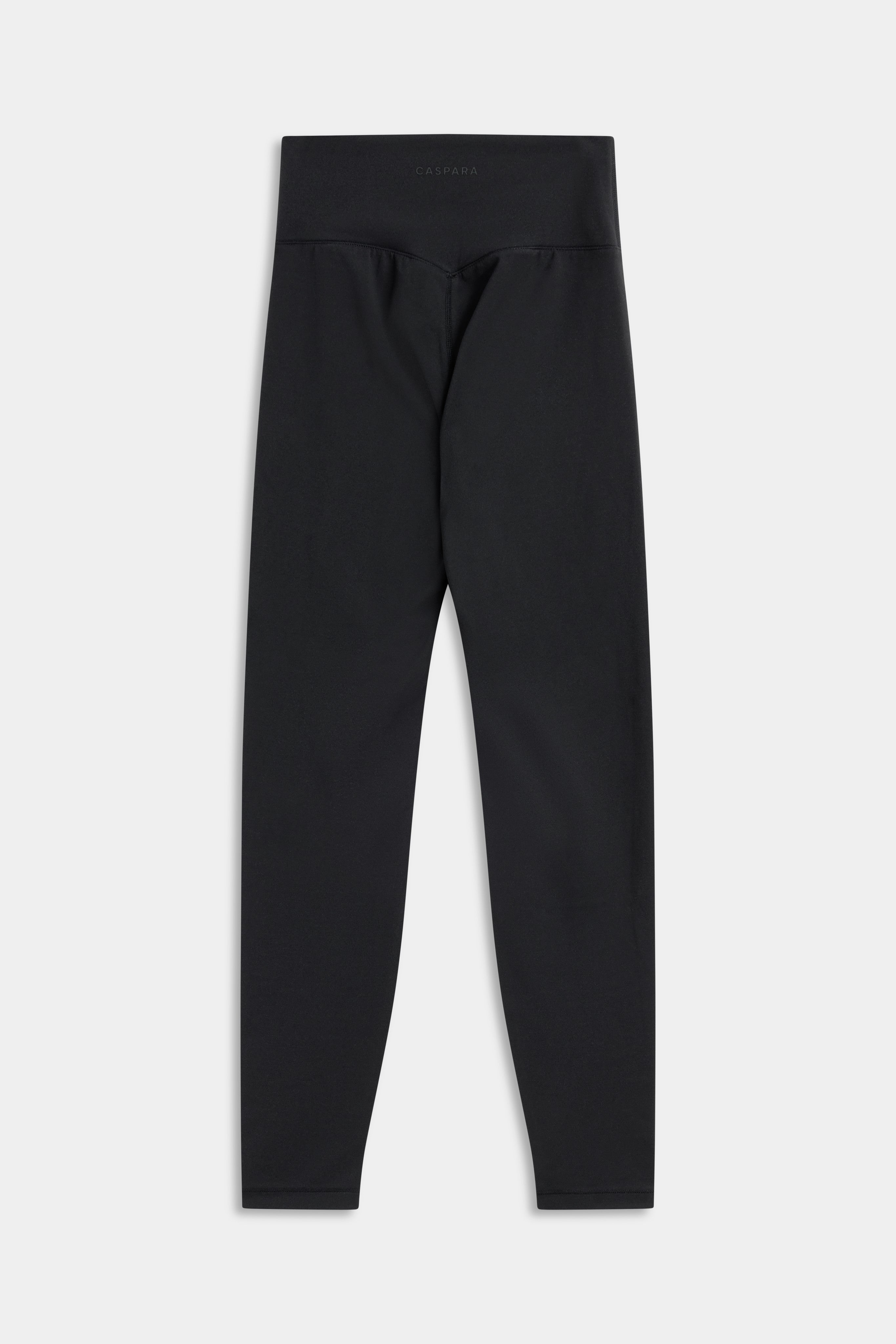 Back view of black CASPARA Cloudform leggings on a light grey studio background.